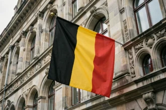 Drapeau belge noir jaune rouge suspendu sur un bâtiment historique en pierre à Bruxelles
